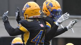 Jordan Alexander #4 of Lawrence, right, celebrates with