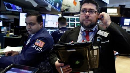 Specialist Dilip Patel, left, and trader Michael Capolino
