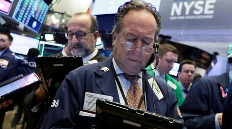 Trader Steven Kaplan, right, on the floor of