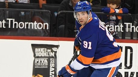 Islanders center John Tavares skates with the puck