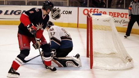 The Rangers' Marek Malik scores a shootout goal