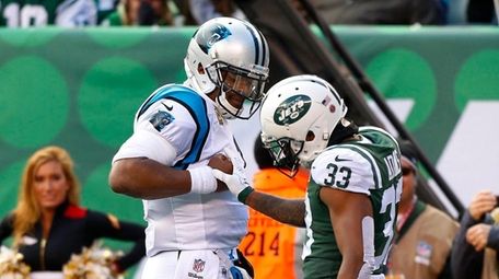 Cam Newton #1 of the Carolina Panthers confronts