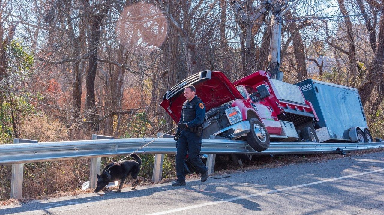 Truck with landscaping equipment crashes onto guardrail, police say