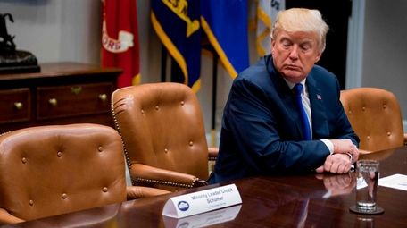 President Donald Trump looks at an empty chair