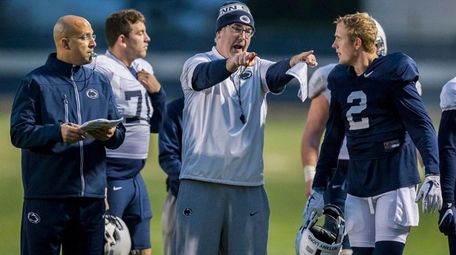 Penn State head coach James Franklin, left, looks