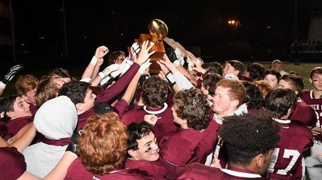 Garden City players and coaches revel with the