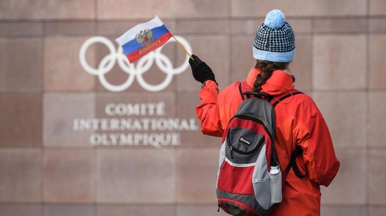 A supporter waves a Russian flag in front