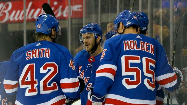 Paul Carey, center, of the Rangers celebrates his