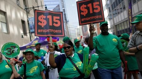 Activists cheer after the New York Wage Board