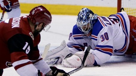 Rangers goaltender Henrik Lundqvist covers the puck in