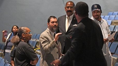 Hempstead School Superintendent Shimon Waronker, center, in tan