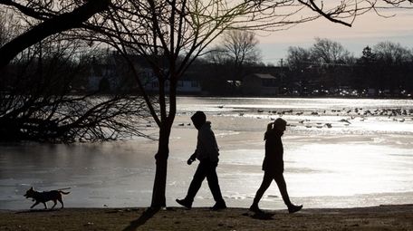 People take in the sunshine and warmer weather