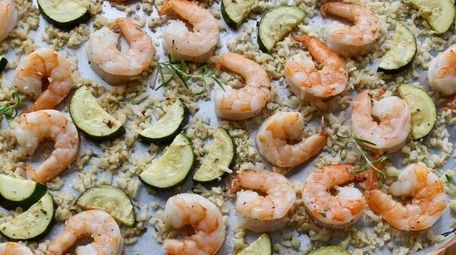 Shrimp, zucchini and cauliflower rice are roasted on