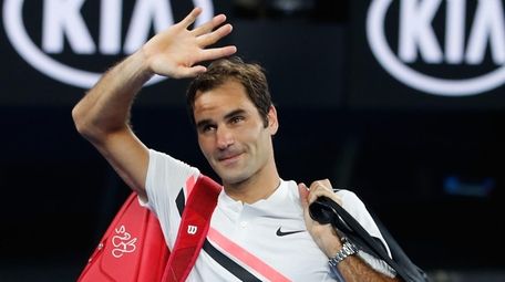 Roger Federer waves to the crowd after winning