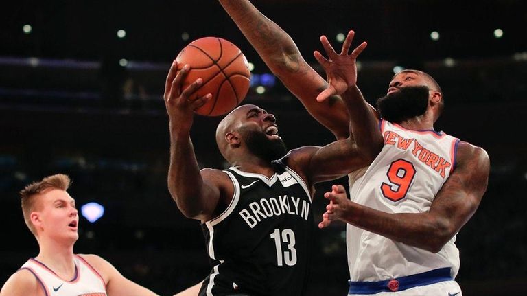 Nets forward Quincy Acy goes up for a