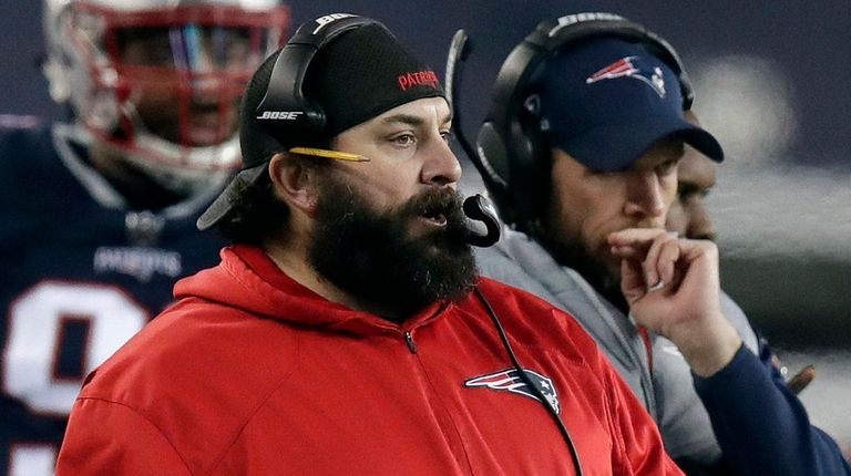 New England Patriots defensive coordinator Matt Patricia watches