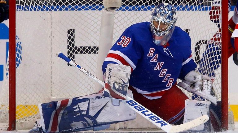 Henrik Lundqvist of the Rangers defends the net