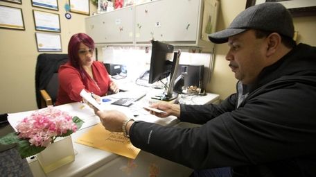 Carrie Roman, left, a bilingual housing counselor, helps