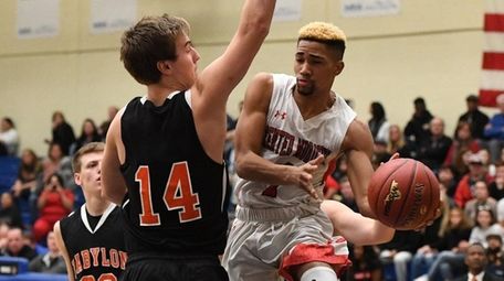 Center Moriches guard Tyiquon Nix passes the ball