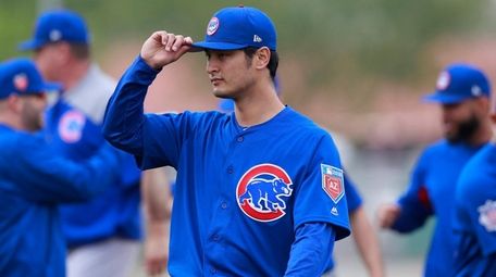 Cubs starting pitcher Yu Darvish walks off the