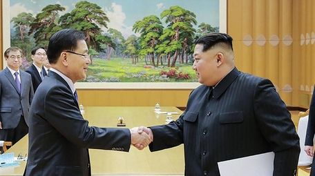South Korean chief delegator Chung Eui-yong, left, greets