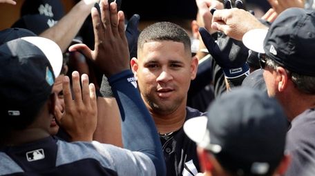 The Yankees' Gary Sanchez is congratulated in the dugout