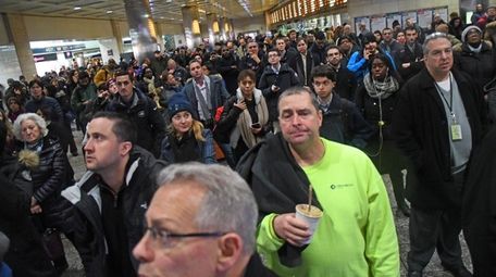 LIRR riders wait at Penn Station during the