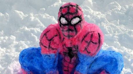 A snow sculpture of Spider-Man made by Herricks