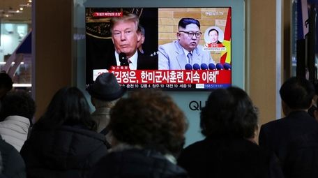 A TV screen shows North Korean leader Kim