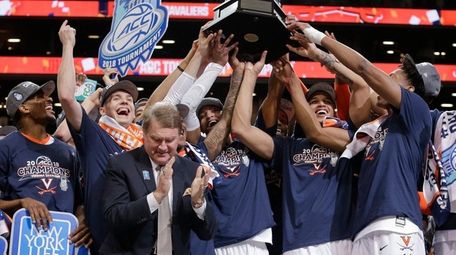 Virginia players celebrate with the championship trophy after