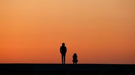 A young couple offers a prayer for victims