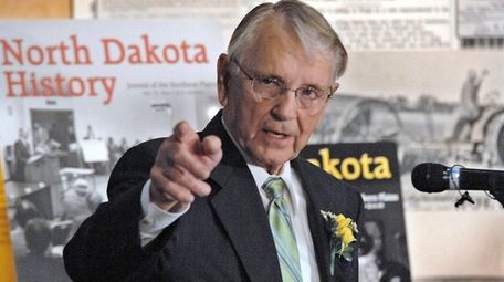 Former Gov. George Sinner gestures while reminiscing about