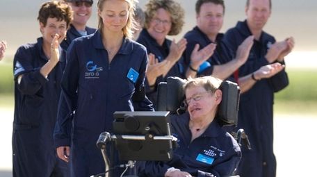 Astrophysicist Stephen Hawking is assisted off the tarmac
