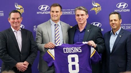 Vikings quarterback Kirk Cousins, second from left, poses