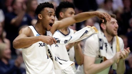 Xavier guard Paul Scruggs reacts from the bench