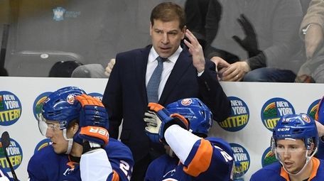 Islanders head coach Doug Weight looks on against