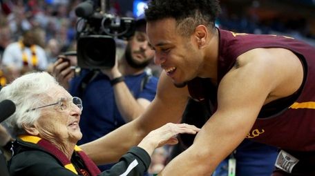 Marques Townes of Loyola-Chicago celebrates with Sister Jean
