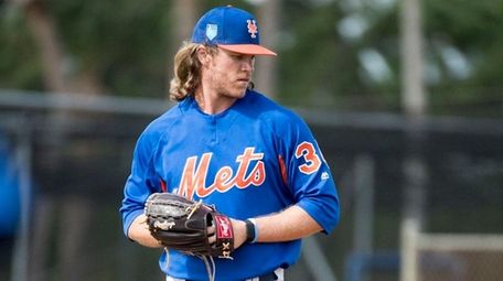 Mets pitcher Noah Syndergaard throws during a spring