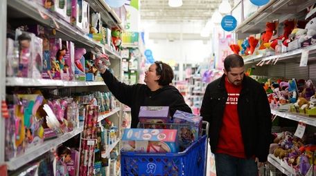 Shoppers browse the shelves at the Toys R