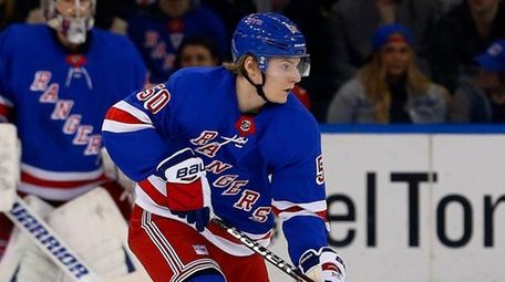 Lias Andersson #50 of the Rangers controls the