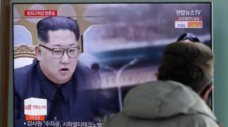 A man watches a TV screen showing file