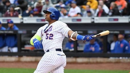 Yoenis Cespedes of the Mets watches after hitting