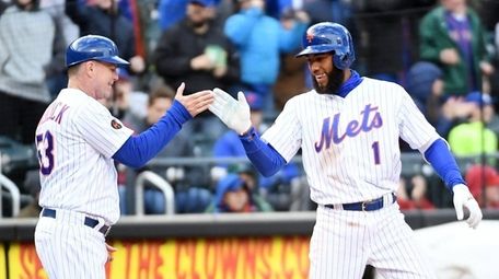 Amed Rosario is congratulated by third base coach