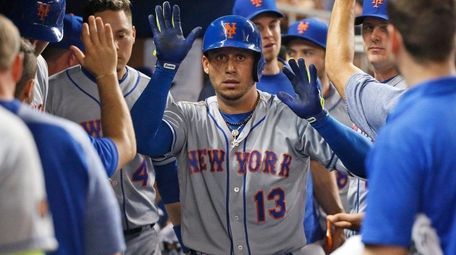 The Mets' Asdrubal Cabrera celebrates with teammates after