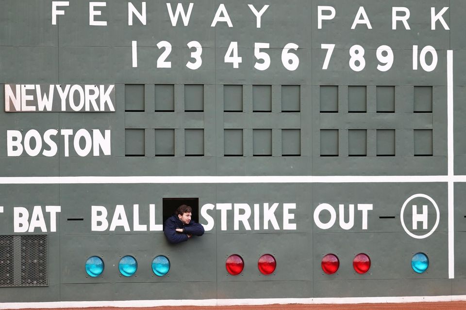 A scorekeeper looks on from inside the Green
