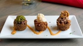 The "mofongo trio" includes grilled beef, garlic shrimp,