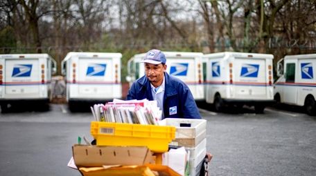 U.S. Postal Service letter carrier Michael McDonald makes