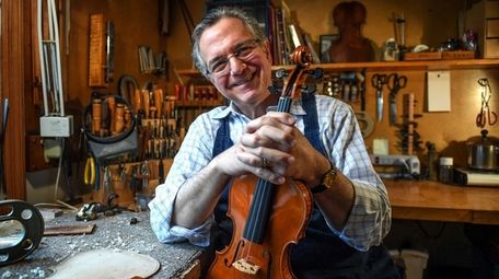 Master violin maker Charles Rufino in his home