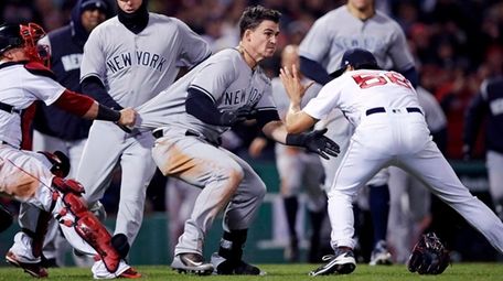 The Yankees' Tyler Austin, center, rushes Red Sox