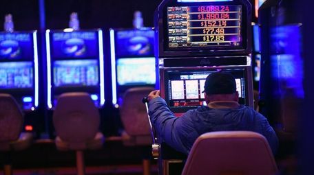 A man uses a video lottery terminal on
